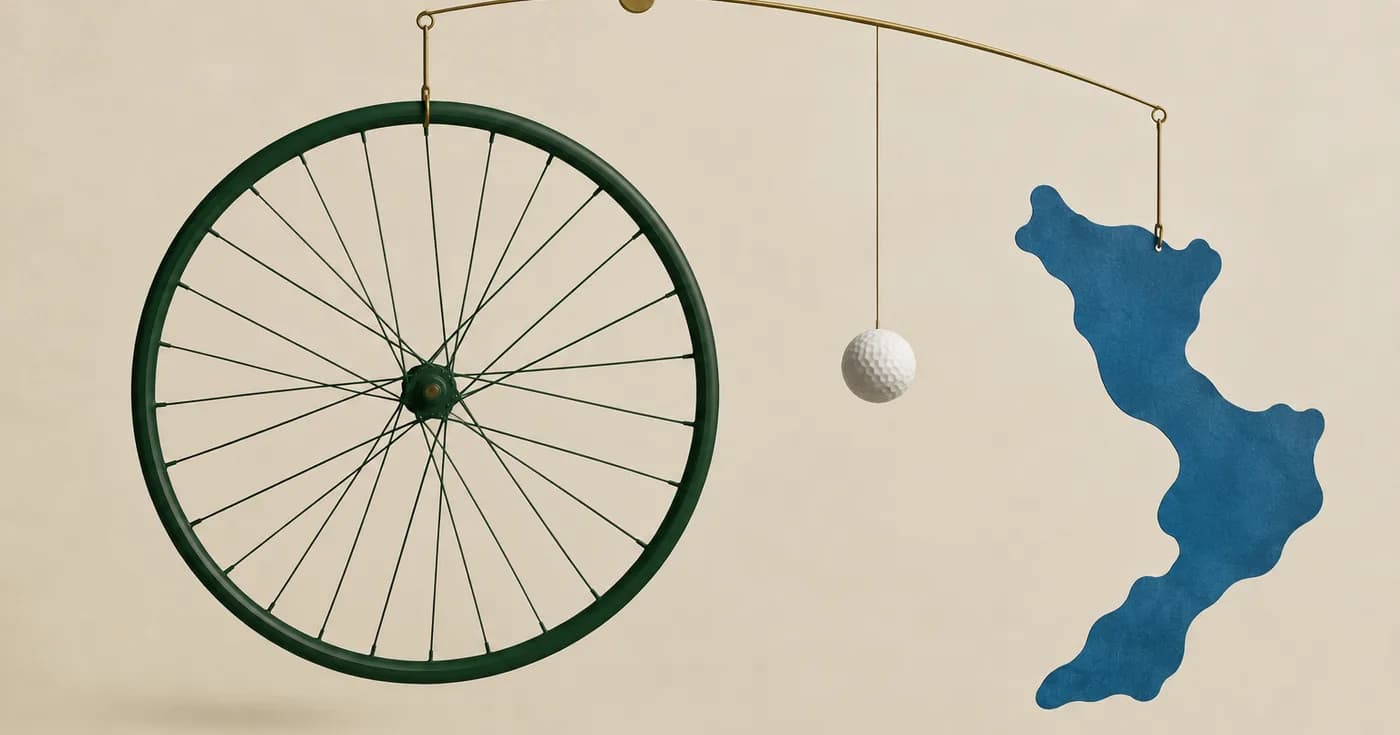 A dark green bicycle wheel, a tiny white golf ball and a blue reservoir-shaped cutout arranged like a mobile